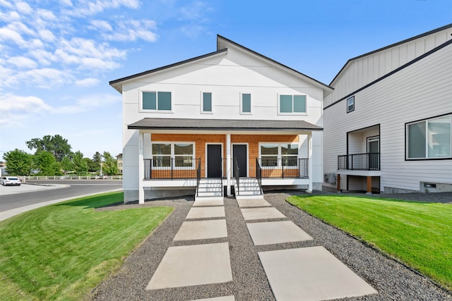 view of front facade featuring covered porch and a front yard