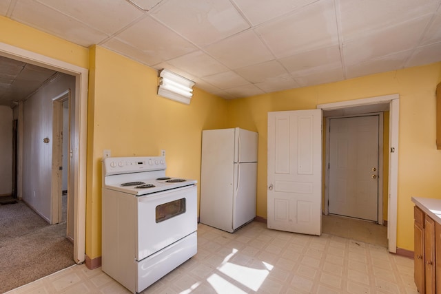 kitchen featuring light floors, white appliances, light countertops, and baseboards