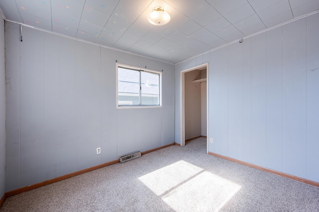 unfurnished bedroom with baseboards, visible vents, and carpet flooring