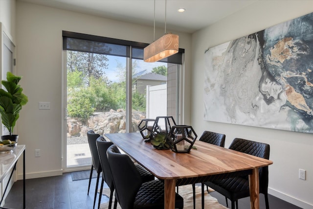 dining space with dark hardwood / wood-style floors