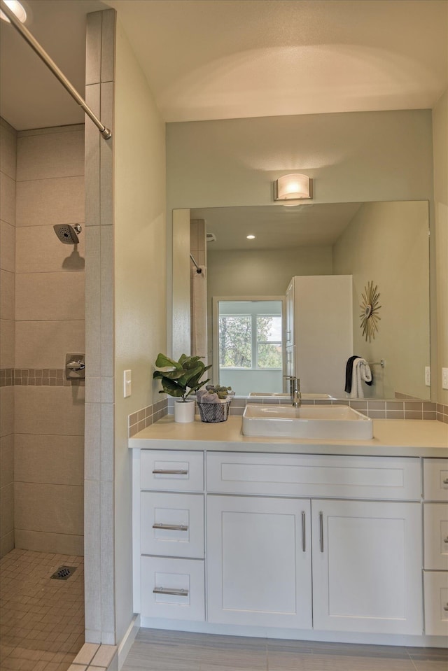 bathroom featuring vanity and tiled shower