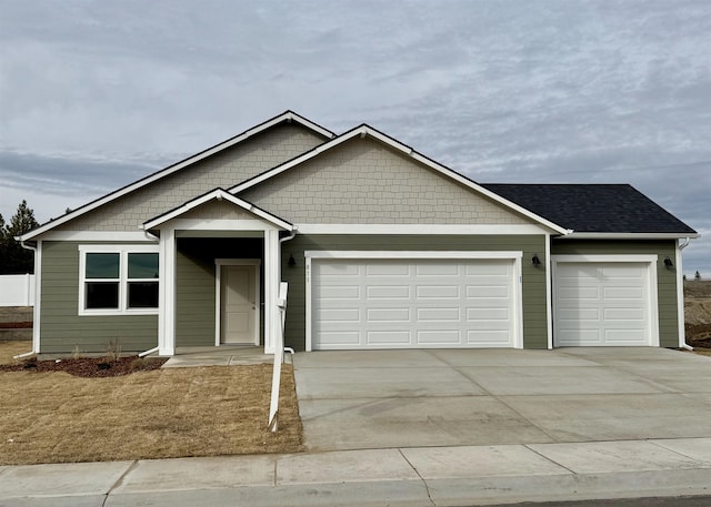 ranch-style house featuring concrete driveway and an attached garage