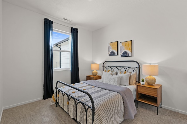 bedroom featuring carpet floors, visible vents, and baseboards