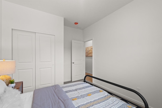 bedroom featuring a closet and baseboards