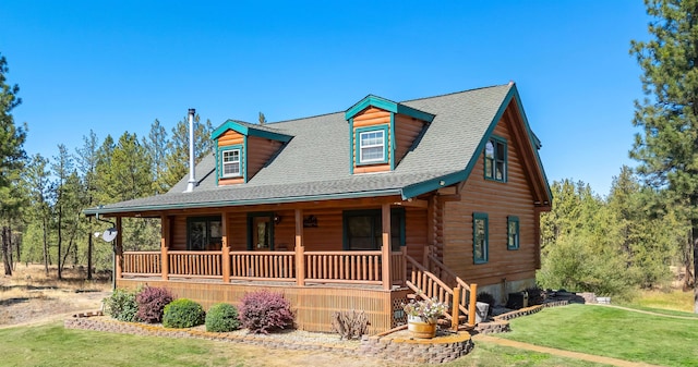 log home featuring a porch and a front lawn