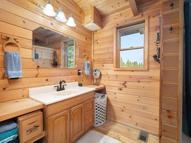 bathroom featuring wood walls, vanity, wood ceiling, and hardwood / wood-style flooring