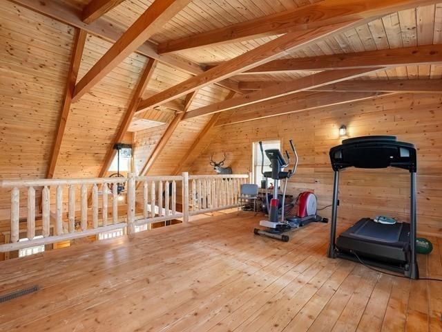 workout area featuring hardwood / wood-style floors, lofted ceiling, and wooden ceiling