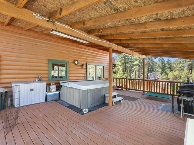 deck featuring a hot tub