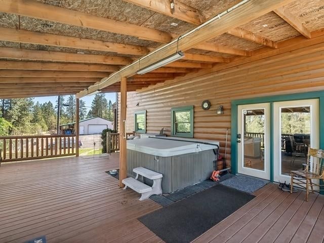 wooden deck featuring a hot tub