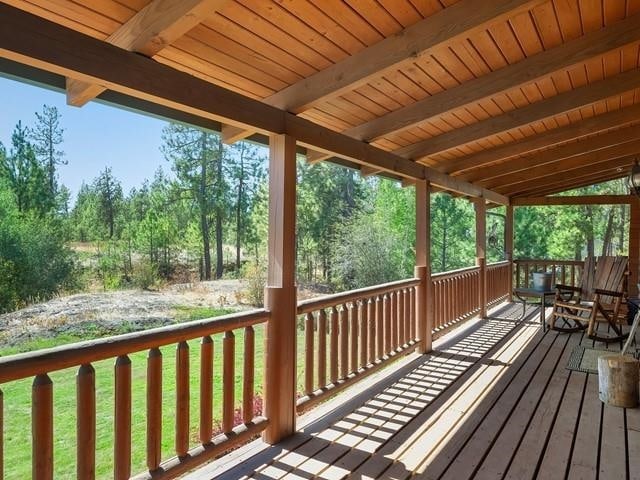 wooden deck featuring a lawn