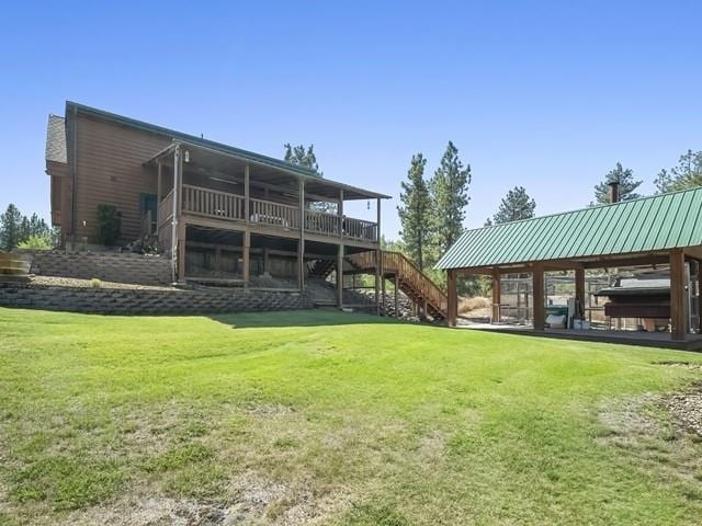 back of house with a sunroom and a yard