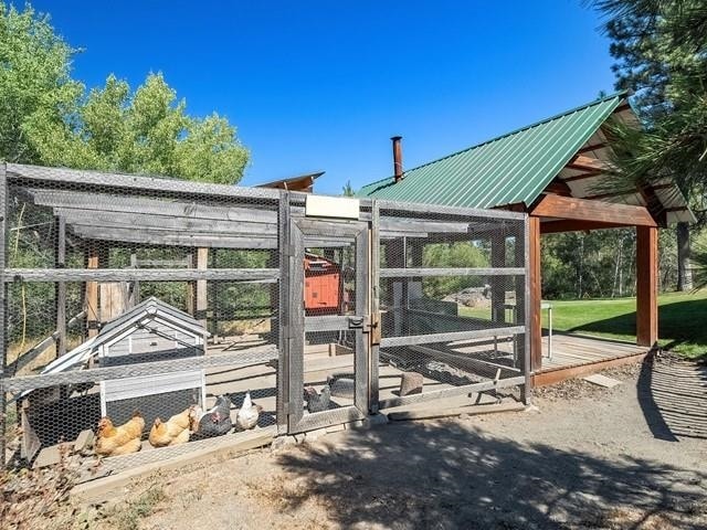 view of gate featuring an outdoor structure