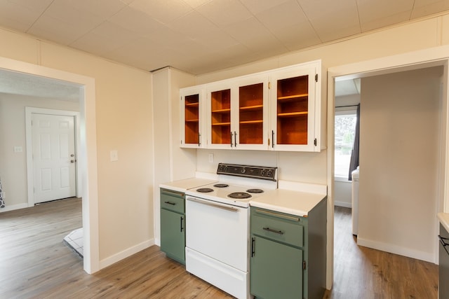 kitchen with white electric range oven, light wood-type flooring, and green cabinetry