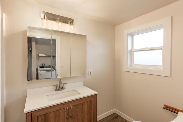 bathroom featuring washer / clothes dryer, vanity, and hardwood / wood-style flooring