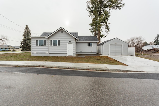 view of front of house with a garage and an outdoor structure