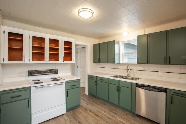 kitchen with light wood-type flooring, sink, electric range, green cabinetry, and dishwasher