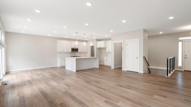 unfurnished living room with light hardwood / wood-style flooring