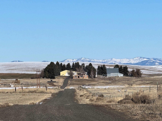 view of street with a rural view and a mountain view