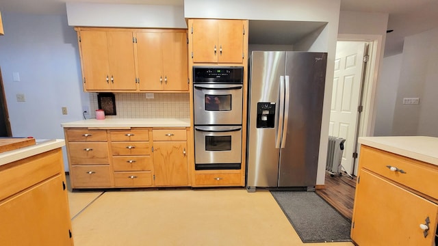 kitchen with light countertops, tasteful backsplash, and stainless steel appliances