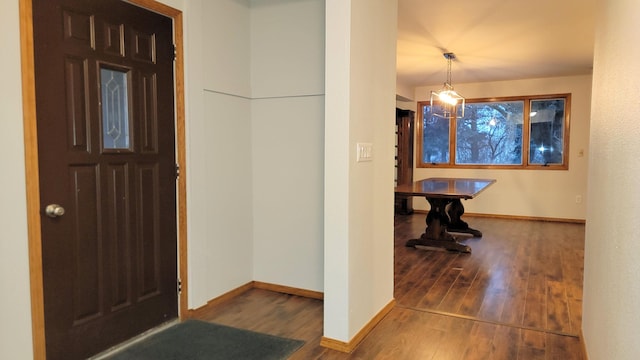 entryway featuring baseboards and wood finished floors