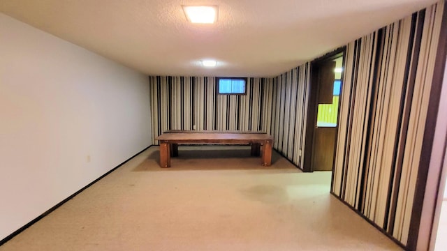 interior space featuring a textured ceiling and carpet floors