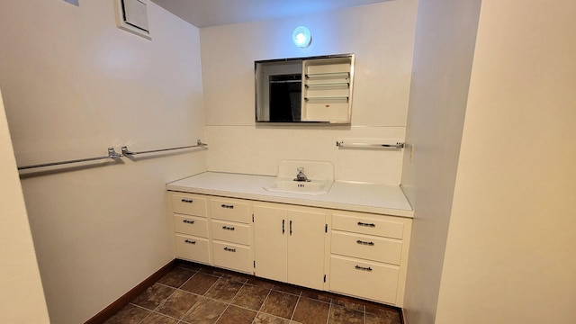 bathroom with vanity and baseboards