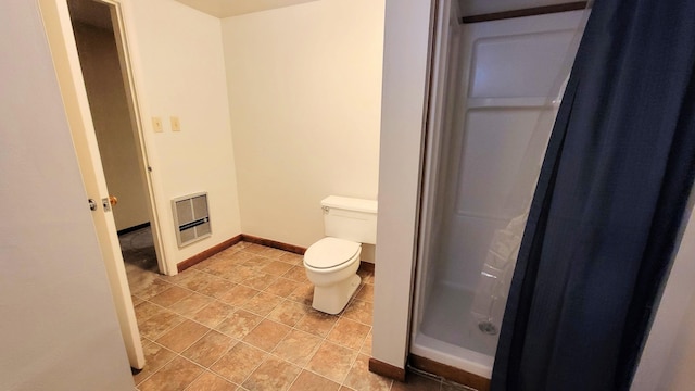 bathroom with tile patterned floors, toilet, a walk in shower, heating unit, and baseboards