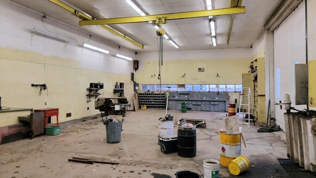 misc room featuring a workshop area and unfinished concrete floors