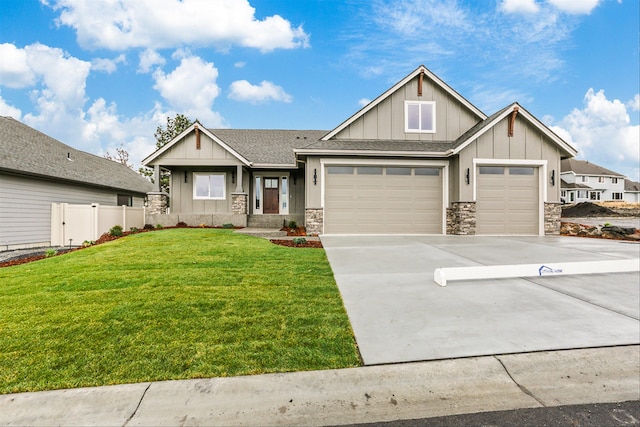 craftsman-style house with a garage and a front lawn