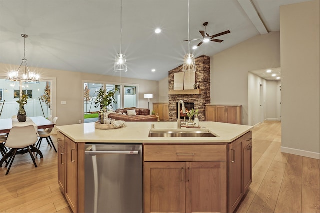 16924 E 16th Ln, Spokane Valley, WA 99037 - kitchen featuring stainless steel dishwasher, a sink, a fireplace, open floor plan, and light wood-type flooring