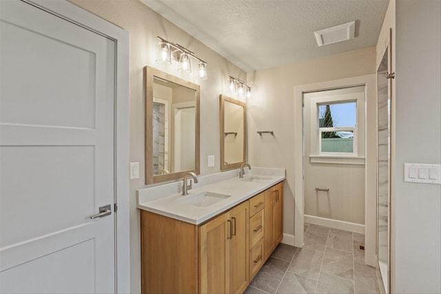 bathroom featuring vanity and a textured ceiling