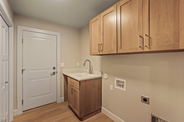 laundry room with sink, washer hookup, cabinets, electric dryer hookup, and light hardwood / wood-style flooring