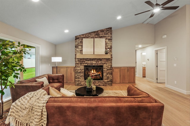 16924 E 16th Ln, Spokane Valley, WA 99037 - living room featuring light wood-style floors, lofted ceiling, ceiling fan, a stone fireplace, and baseboards