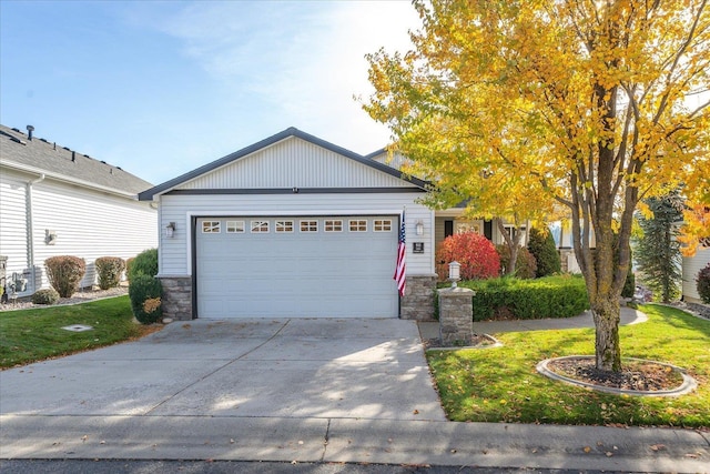 view of front of house with a front yard and a garage