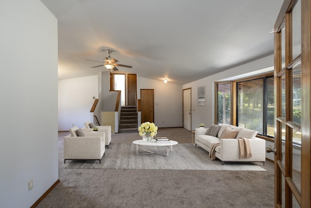 carpeted living room featuring ceiling fan and lofted ceiling