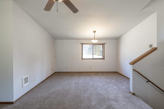 carpeted spare room with ceiling fan