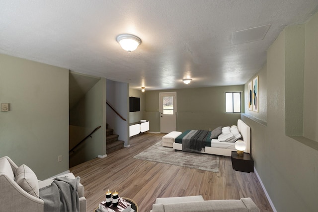 bedroom featuring a textured ceiling and light wood-type flooring