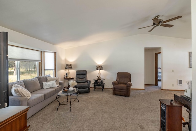 living room featuring ceiling fan, light colored carpet, and lofted ceiling