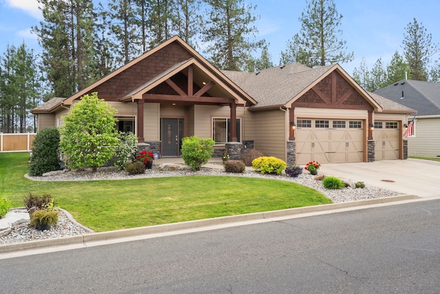 craftsman-style home featuring a front lawn and a garage