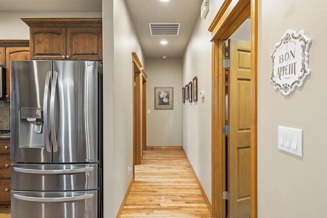 kitchen featuring light hardwood / wood-style flooring and stainless steel fridge