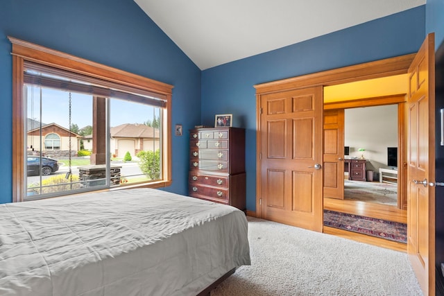 bedroom featuring vaulted ceiling and carpet flooring