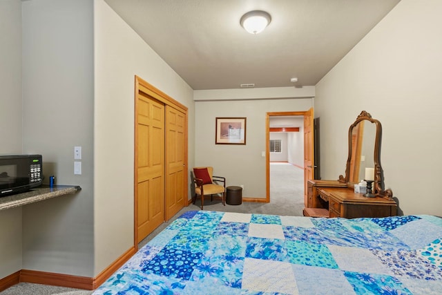 bedroom featuring light colored carpet and a closet