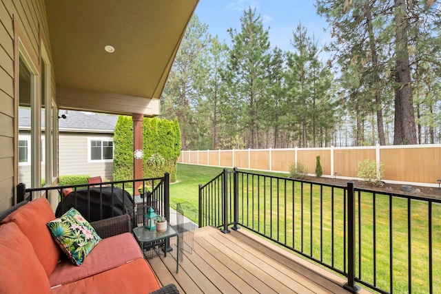 wooden deck featuring a lawn