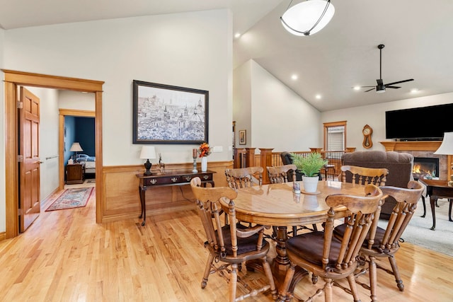 dining space with lofted ceiling, ceiling fan, and light hardwood / wood-style floors