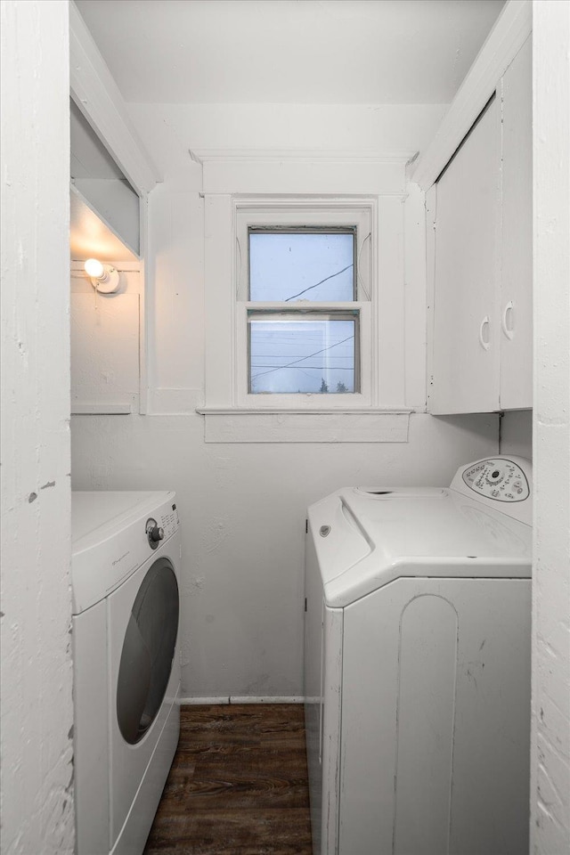 laundry area with dark hardwood / wood-style floors and washing machine and clothes dryer