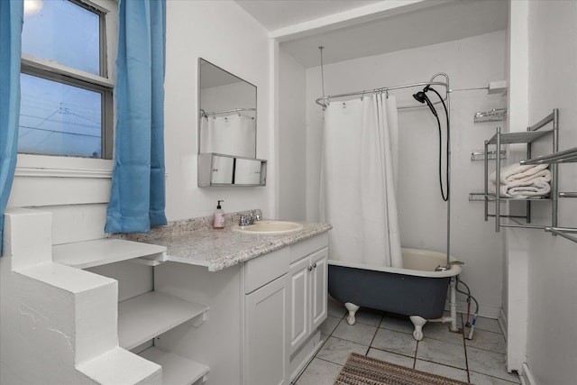 bathroom featuring shower / bath combo with shower curtain, vanity, and tile patterned flooring