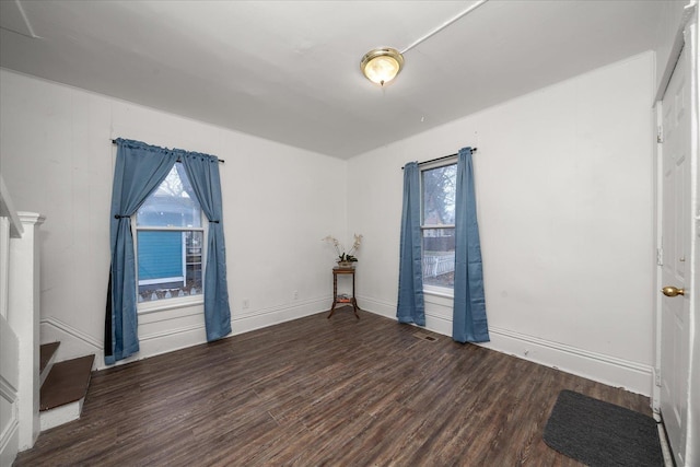 unfurnished room featuring dark hardwood / wood-style flooring