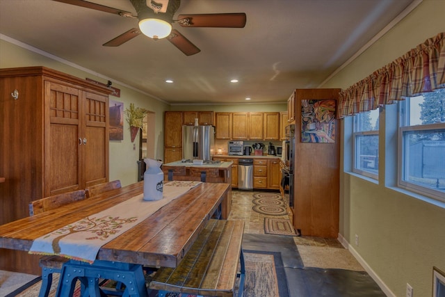 living room featuring a wood stove and ceiling fan