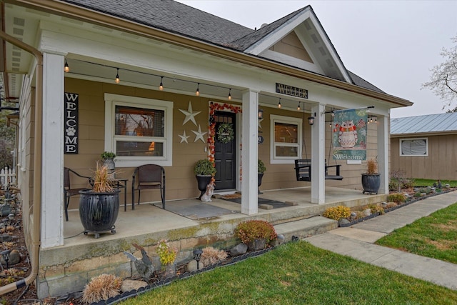 view of front of property with a porch and a front lawn