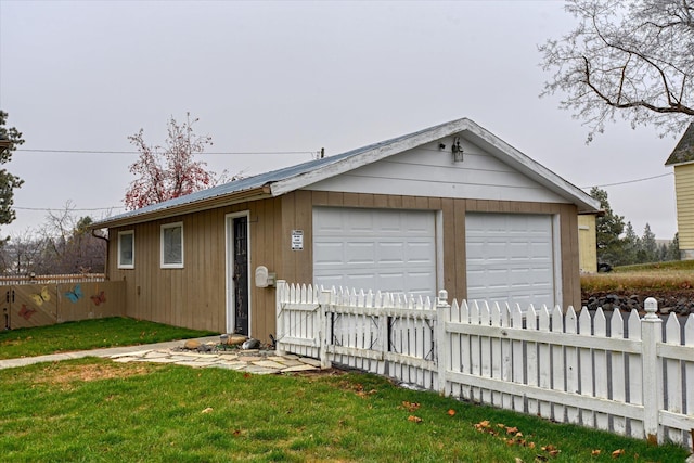 garage featuring a lawn